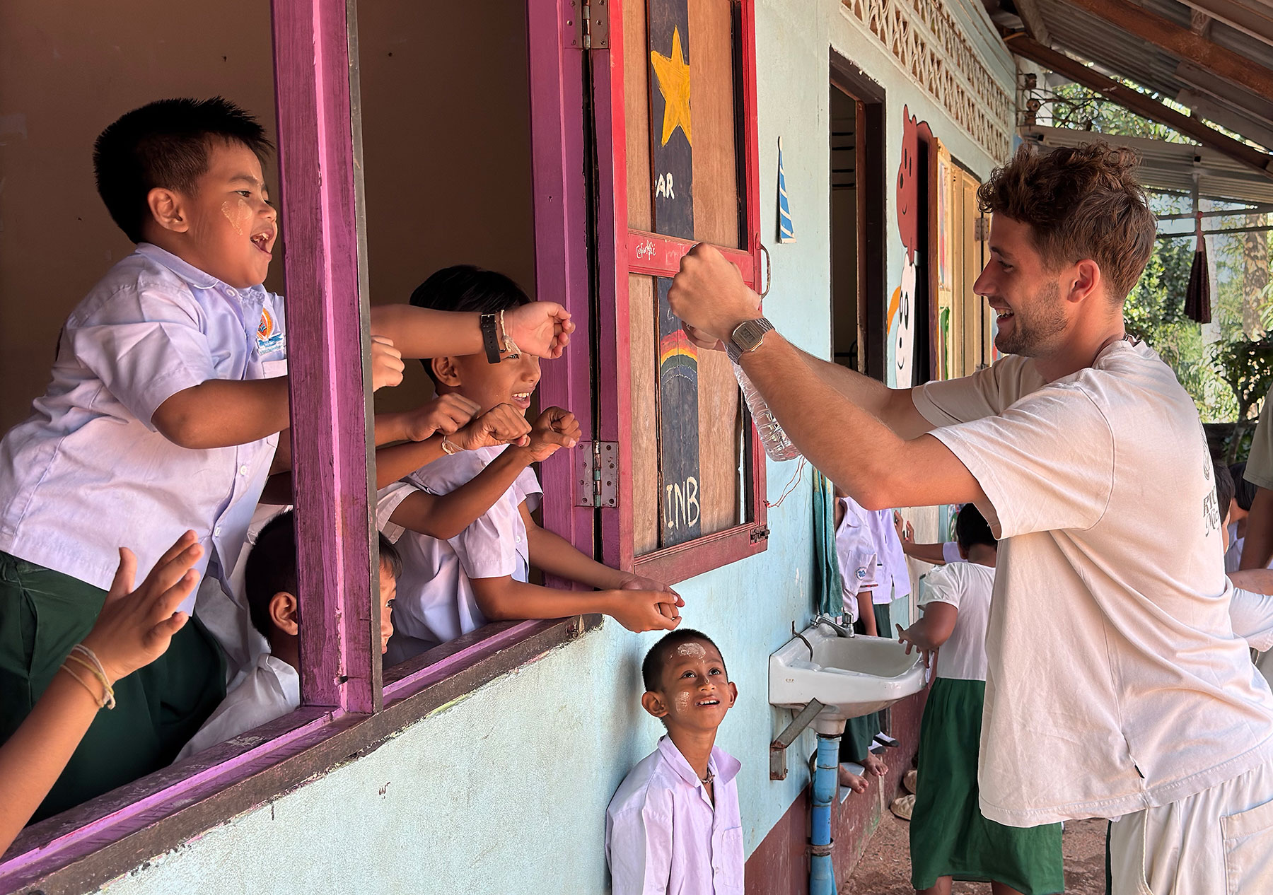 Andaman Center June 2026 newsletter cover shows a volunteer playing with the students
